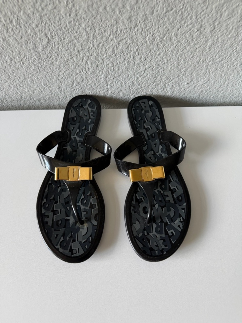 Salvatore Ferragamo Black Jelly Thong Sandals with Gold Bow Accent